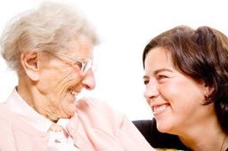 An older woman smiling at a younger woman
