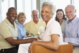 a group of people sitting at a table eating