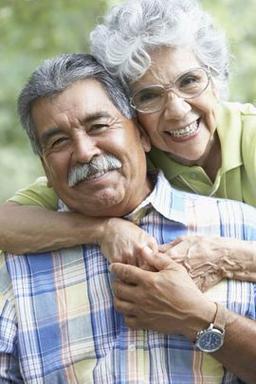 a woman hugging an older man from behind