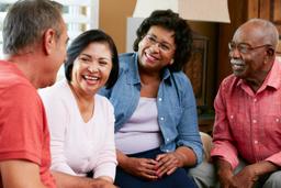 Two couples talking together in a gathering room