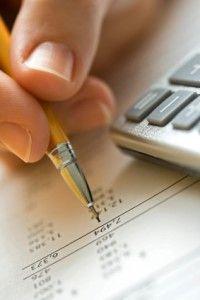An up close view of a pencil hovering over a financial report