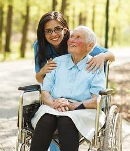an older woman in a wheelchair and her caregiver